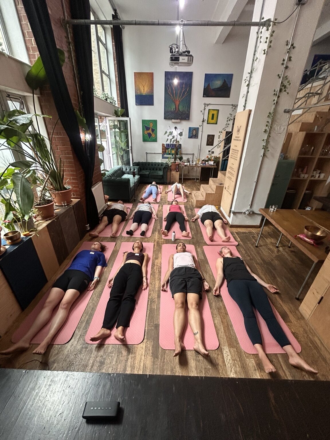 Guests resting on their mats at the end of the yoga practice
