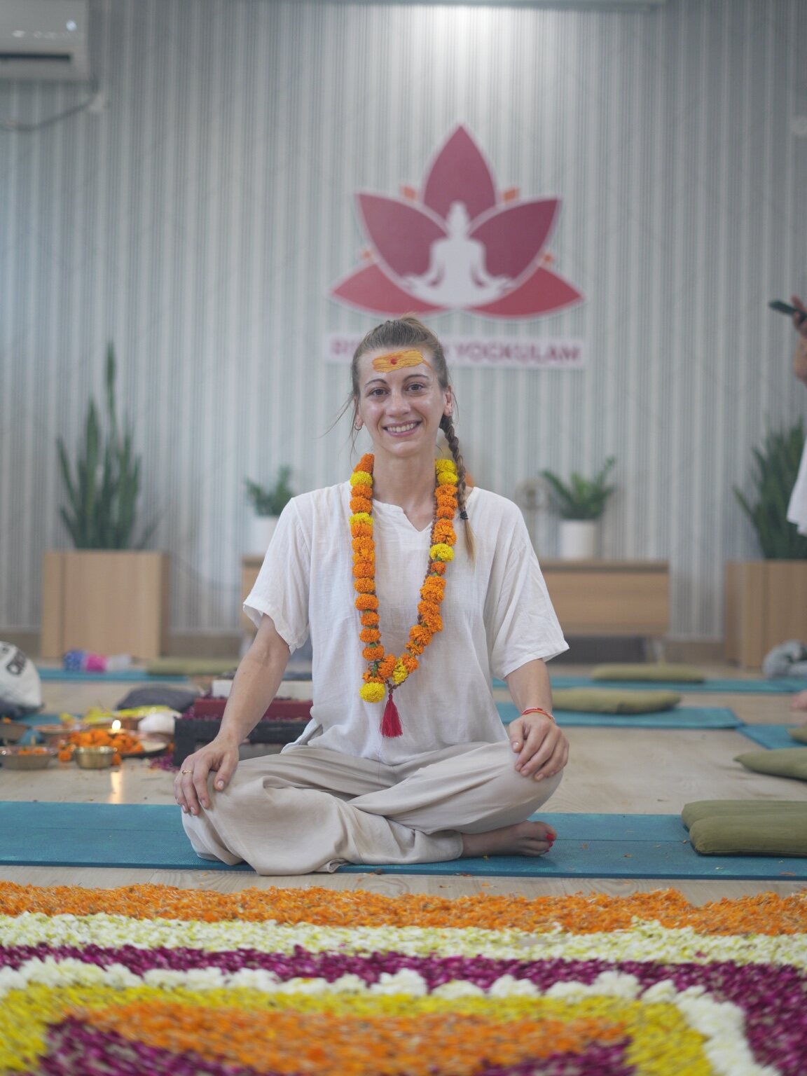 Vanessa seated cross-legged during her yoga teacher training at Rishikesh Yogkulam
